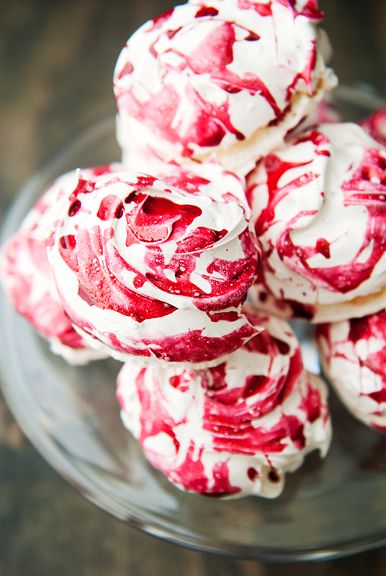 Close-up of pink and white swirled meringue cookies.